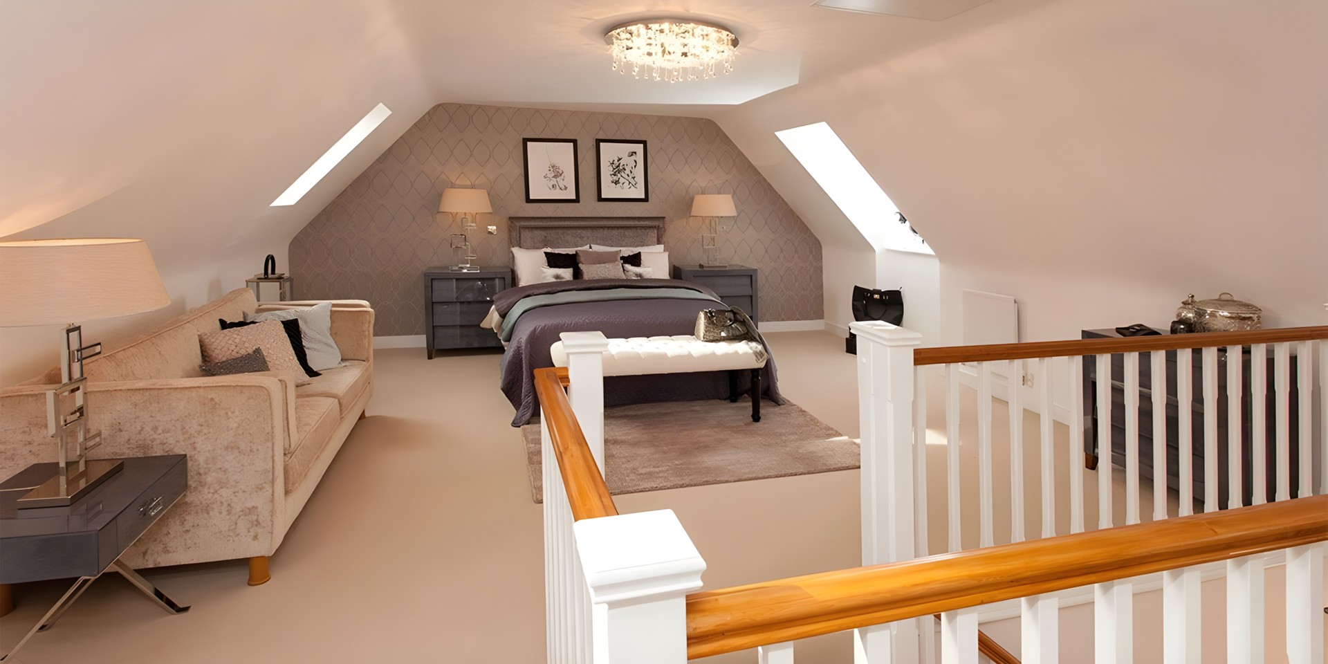 A loft bedroom: skylights in the slope of the roof, a white balustrade at the head of the stair and a pendant light.